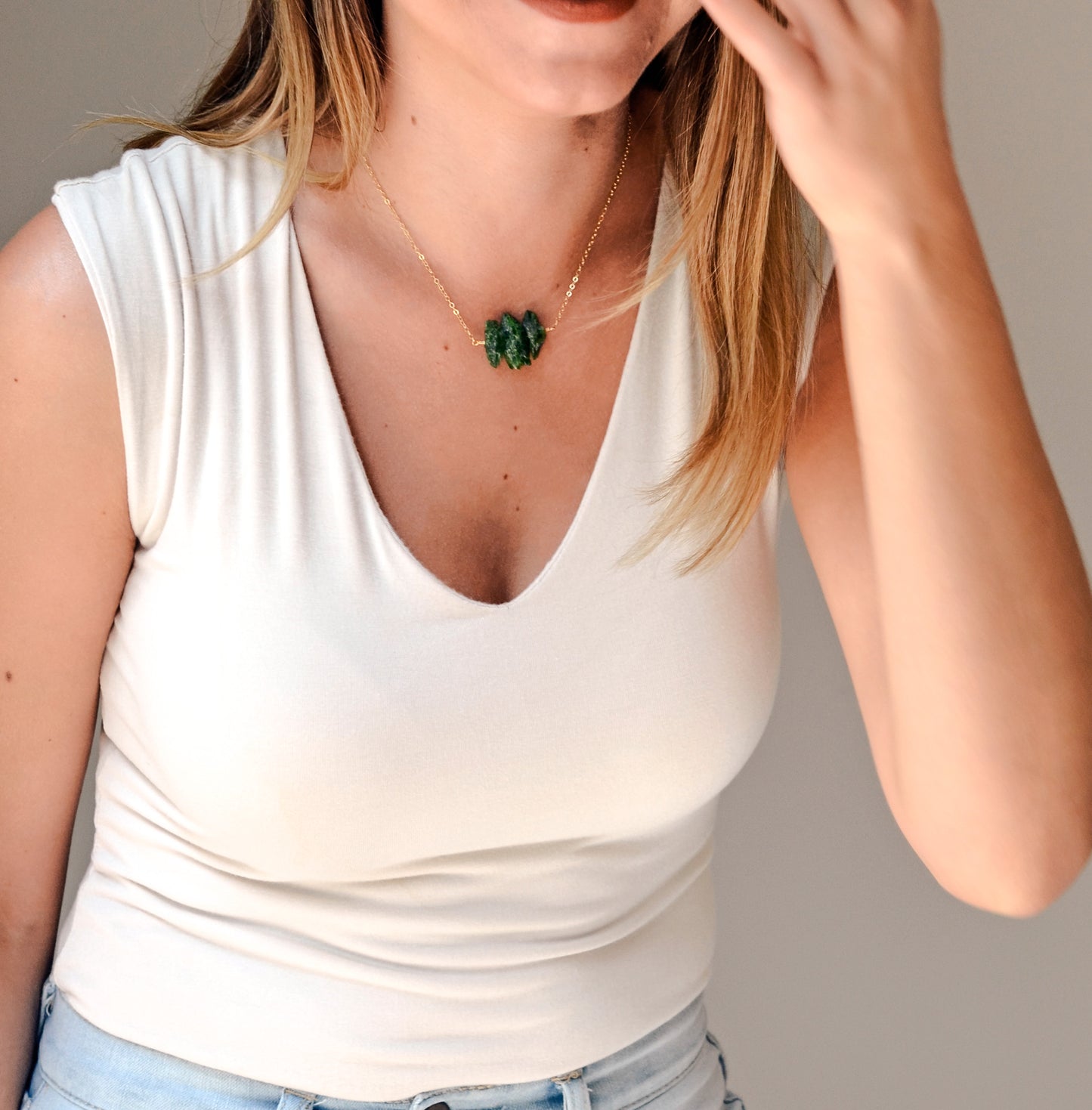Natural green Chrome Diopside raw crystals set onto a gold filled chain. Modeled image.