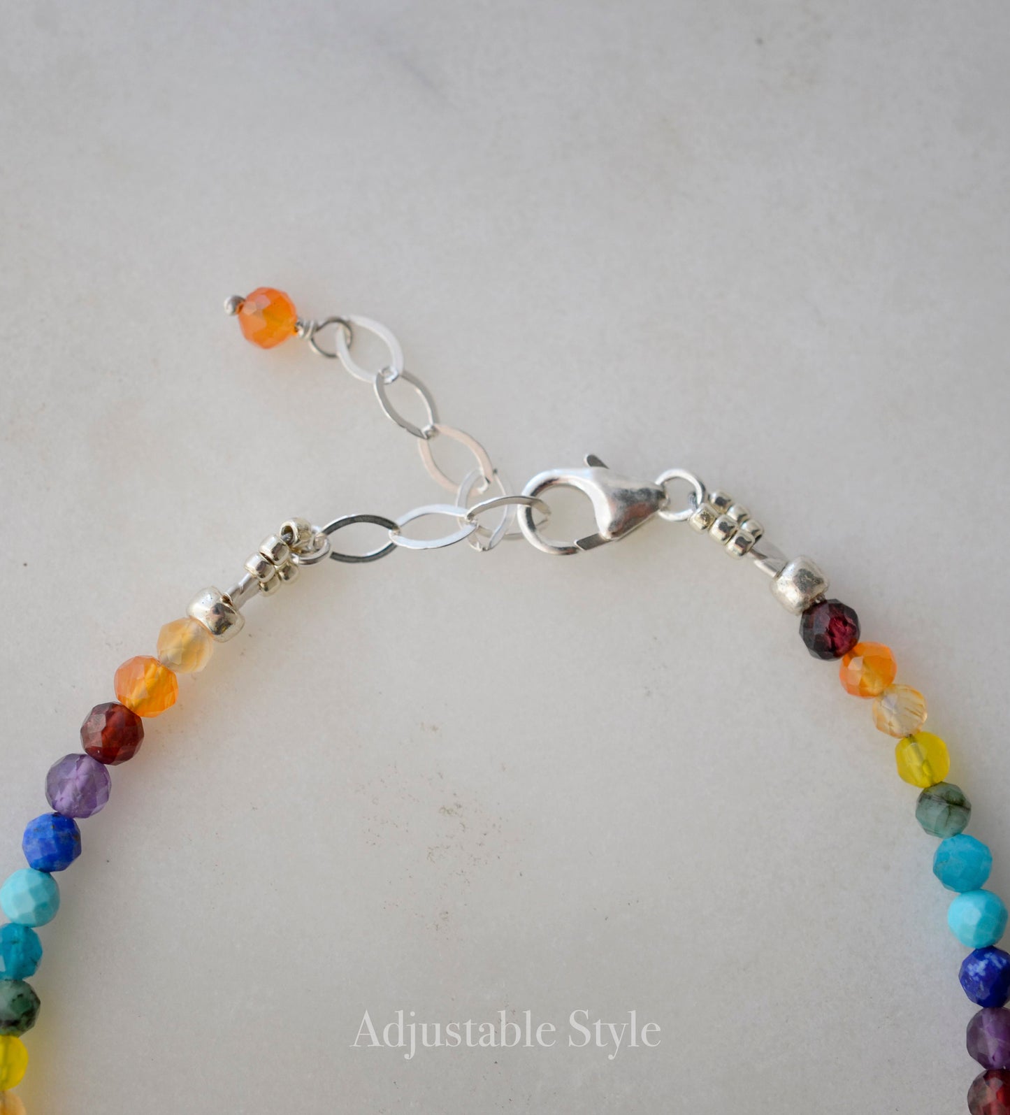 Tiny gemstone beaded bracelet in rainbow colors. Colors include: blue, green, yellow, red, orange, and purple.