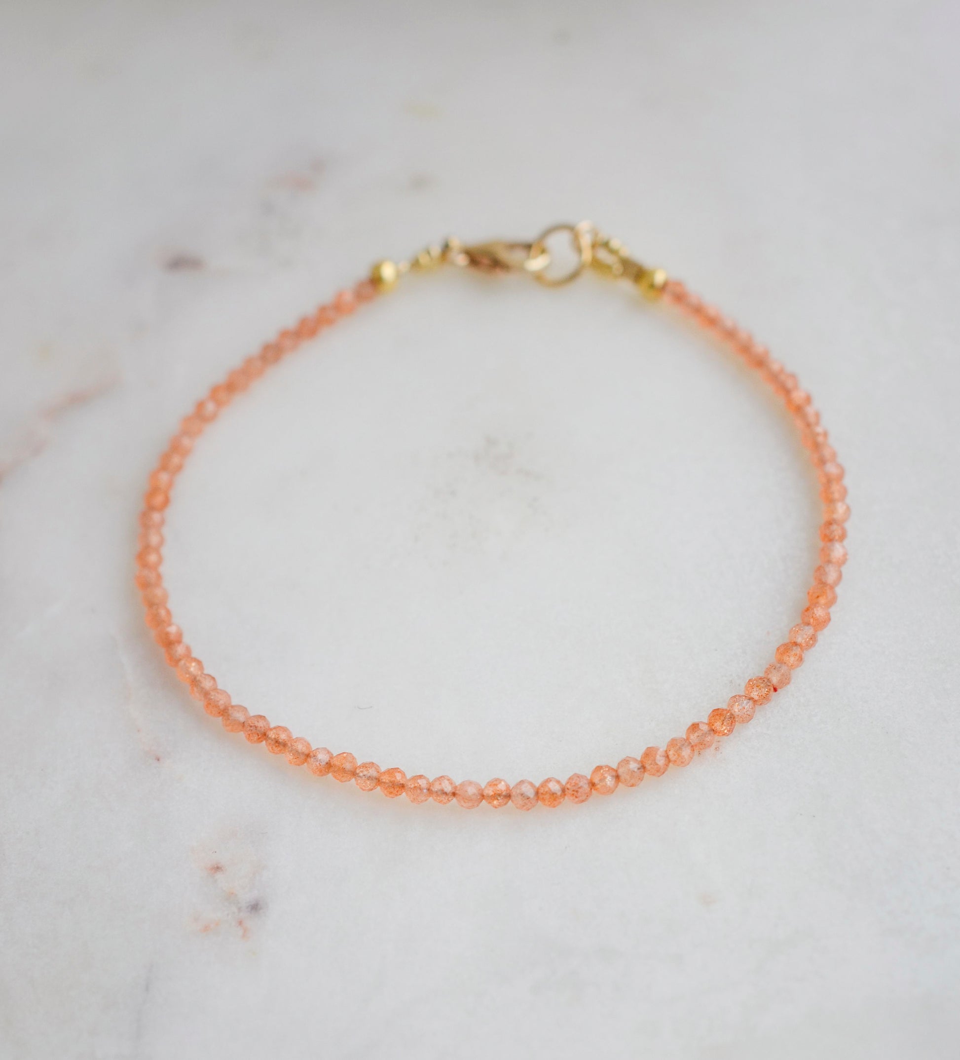 Genuine orange Sunstone beaded bracelet. The stones are round and faceted.