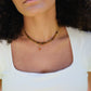 Natural orange Sunstone necklace. The stone is a faceted round and set onto a 14k gold filled chain. Modeled image.