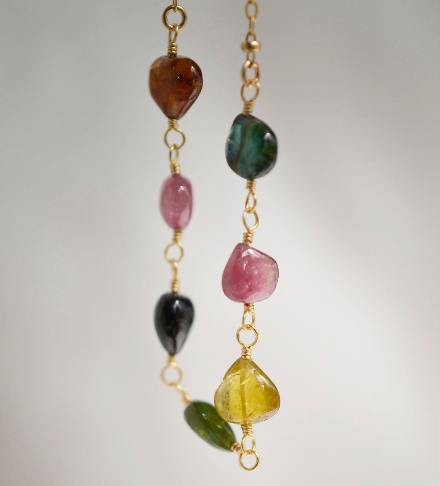Multi color Tourmaline drops chain necklace. Shown in gold. Stone colors include: pink, green, black, yellow, or brown.