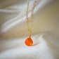 Natural orange Carnelian teardrop gemstone set onto a 14k gold filled chain.