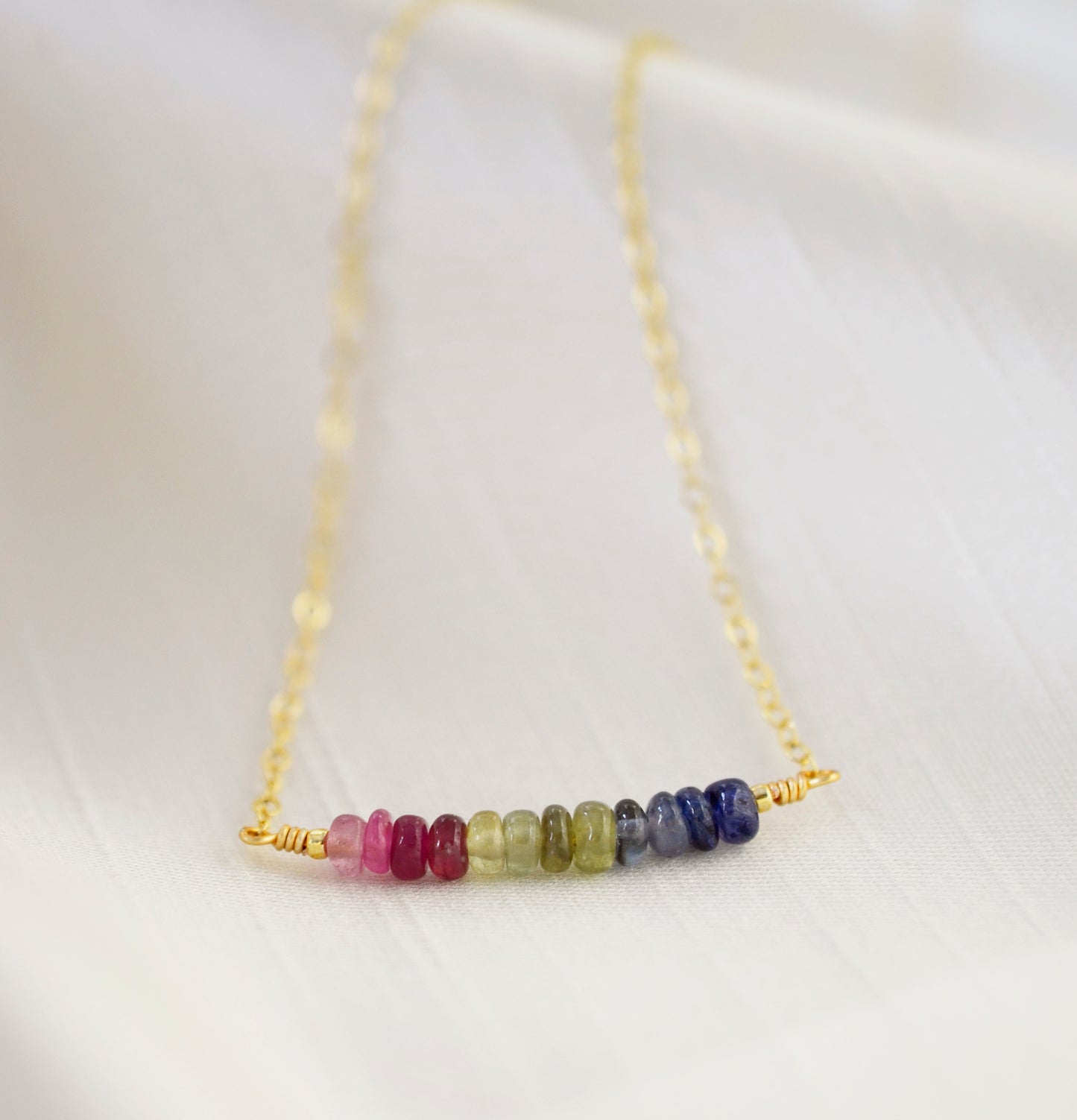 Multi color sapphire necklace. Blue, pink, green, yellow sapphires arranged into a bar pendant. Made in Sterling Silver or Gold Filled.
