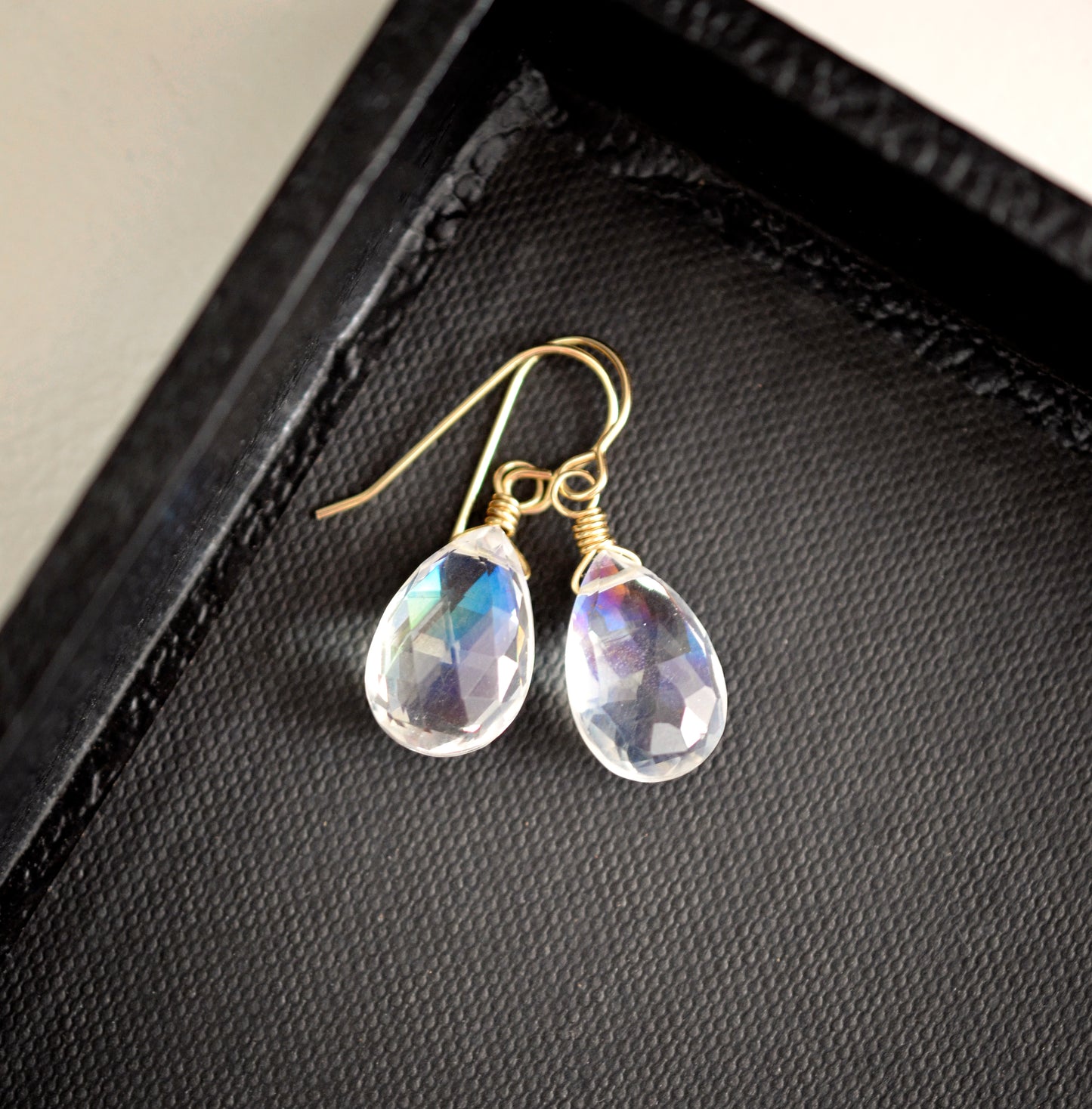 Rainbow colored mystic topaz earrings in 14k gold filled. The stone is a teardrop shape and shifts different rainbow colors..