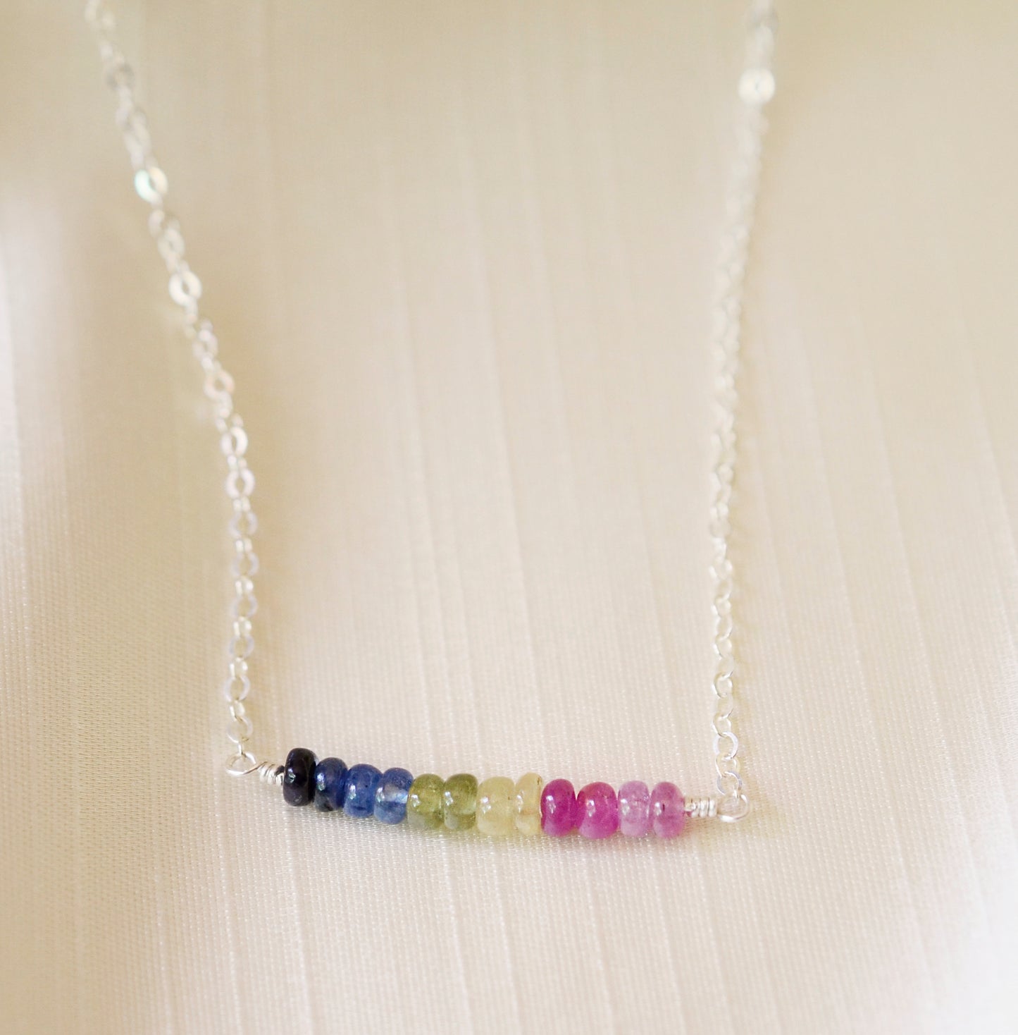 Multi color sapphire necklace. Blue, pink, green, yellow sapphires arranged into a bar pendant. Made in Sterling Silver or Gold Filled.
