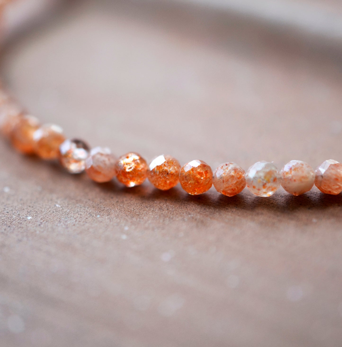 Close up of natural Sunstone beads. Delicate Handmade Beaded Sunstone Bracelet.