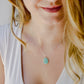 Natural raw Amazonite crystal slice set onto a sterling silver chain. Modeled image.