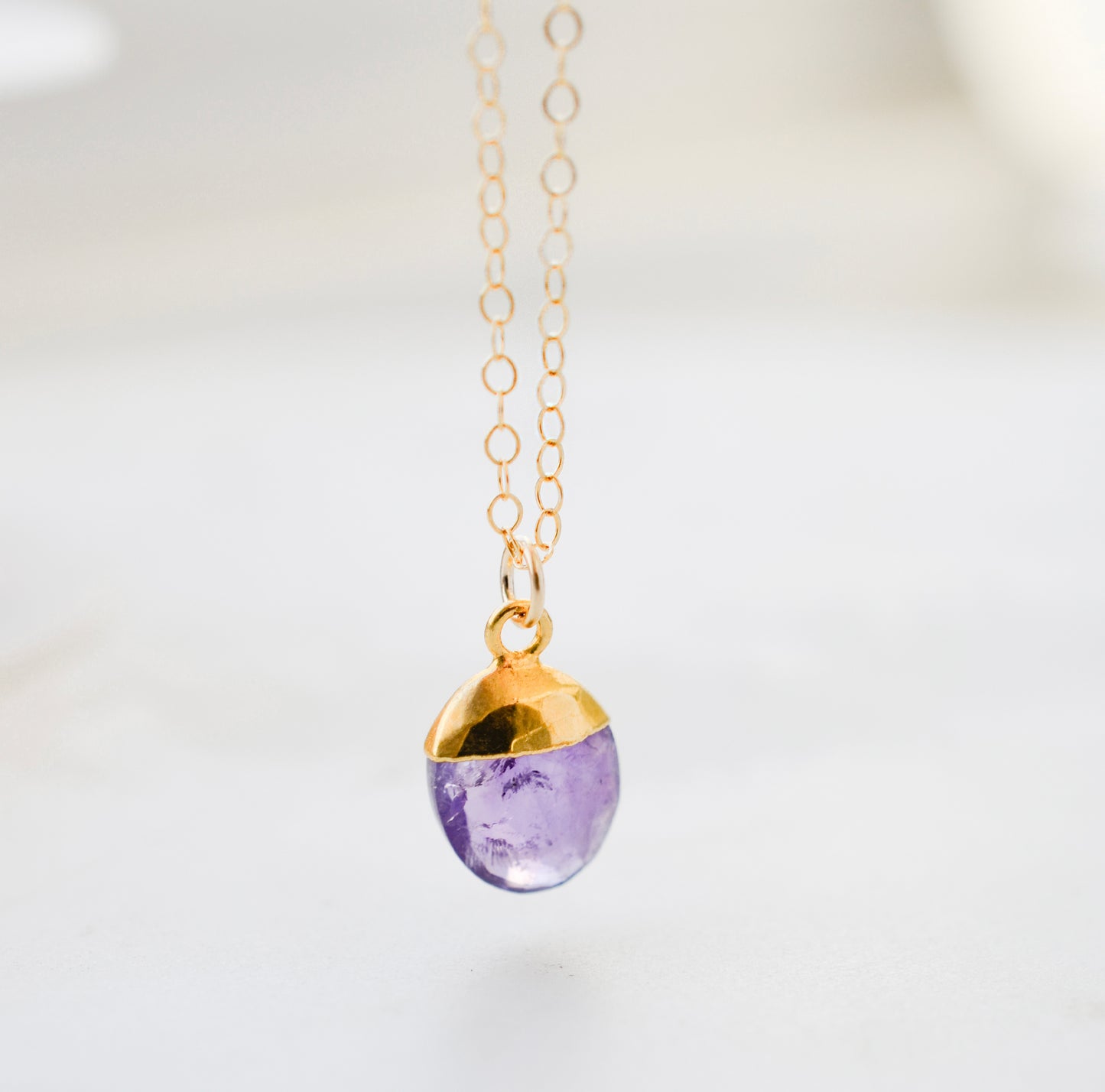 A natural purple amethyst oval drop necklace pendant. Handmade in Connecticut in 14k gold filled or sterling silver.