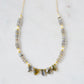 A handmade, beaded labradorite and pearl gemstone necklace with five labradorite teardrops in the front. Shown in 14k gold filled.