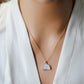 Modeled image. This necklace is handmade with a natural white druzy quartz pendant in a half-circle or crescent shape. Available in 14k gold filled.