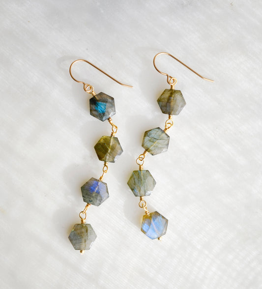 Long labradorite earrings designed for those who love a statement. These earrings feature four hexagonal gemstones with blue and green flash dangling in a straight line. Available in sterling silver or 14k gold filled.