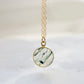 A genuine, natural moss agate circle shaped pendant set on a 14k gold filled chain. This minimalist, dainty, smooth polished pendant is handmade in Connecticut by Gemnia Jewelry.
