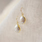 Natural white freshwater pearl dangle earring. The pearl is set in 22k gold electroplate and suspended from 14k gold filled earwires.