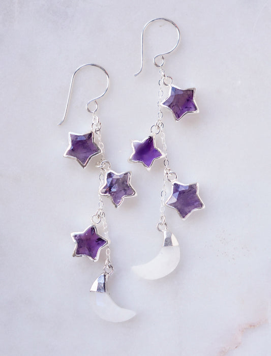 Three natural purple amethyst gemstone stars dangle atop rainbow moonstone crescent moons in these earrings. Shown in sterling silver.