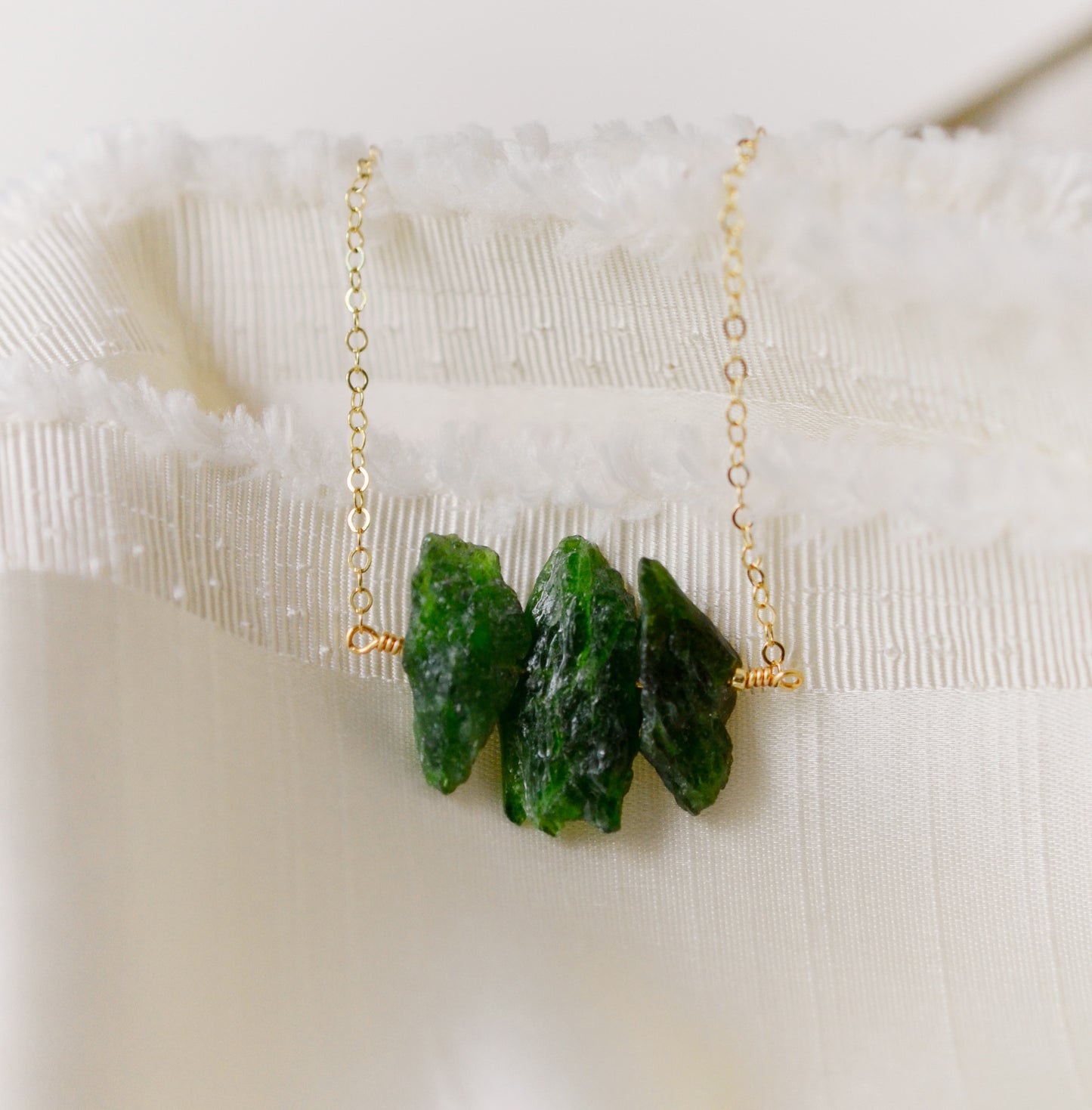 Natural green Chrome Diopside raw crystals set onto a gold filled chain.
