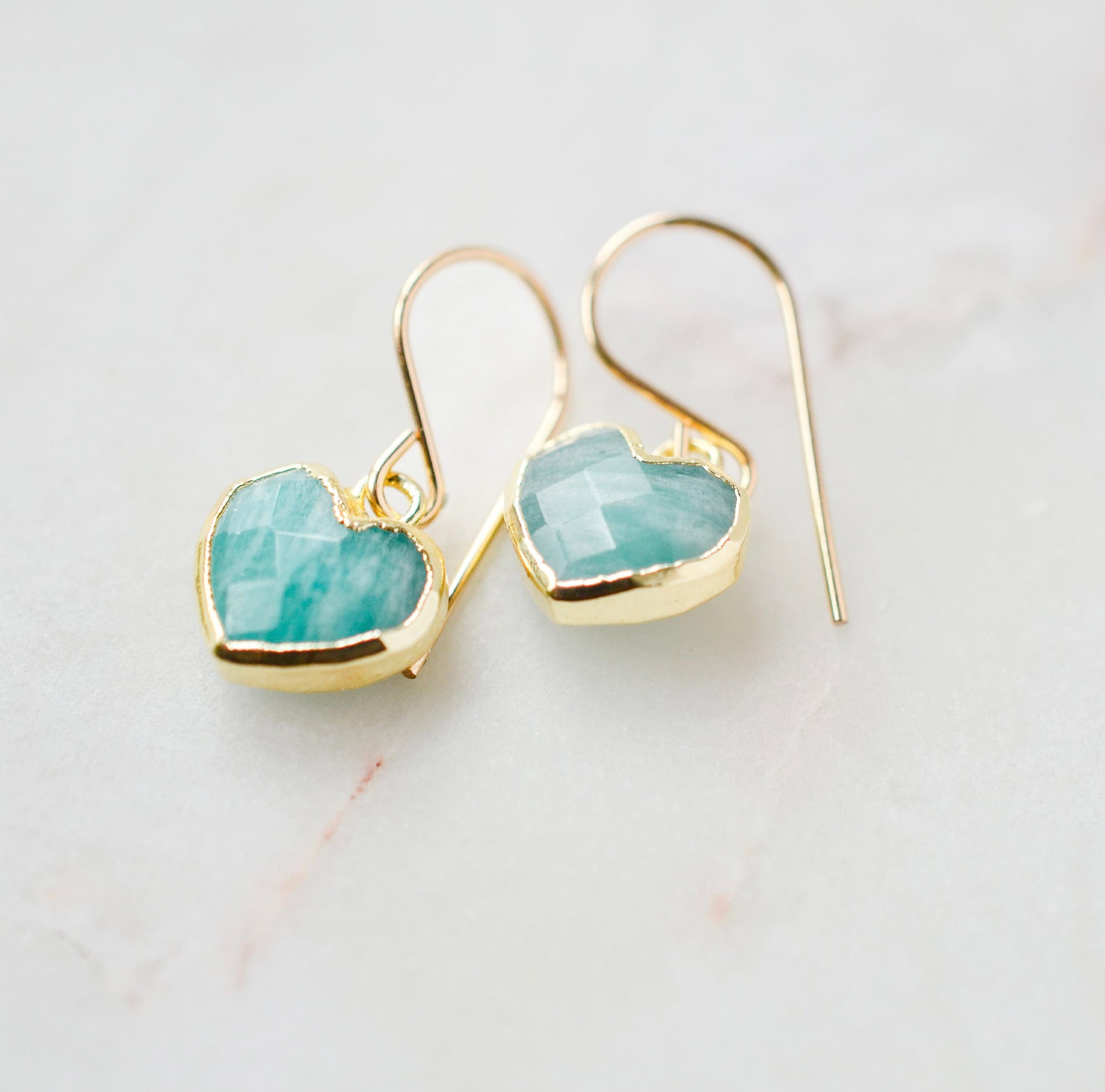 Aqua blue Amazonite gemstone heart earrings in gold. Modeled image. Natural Stones.