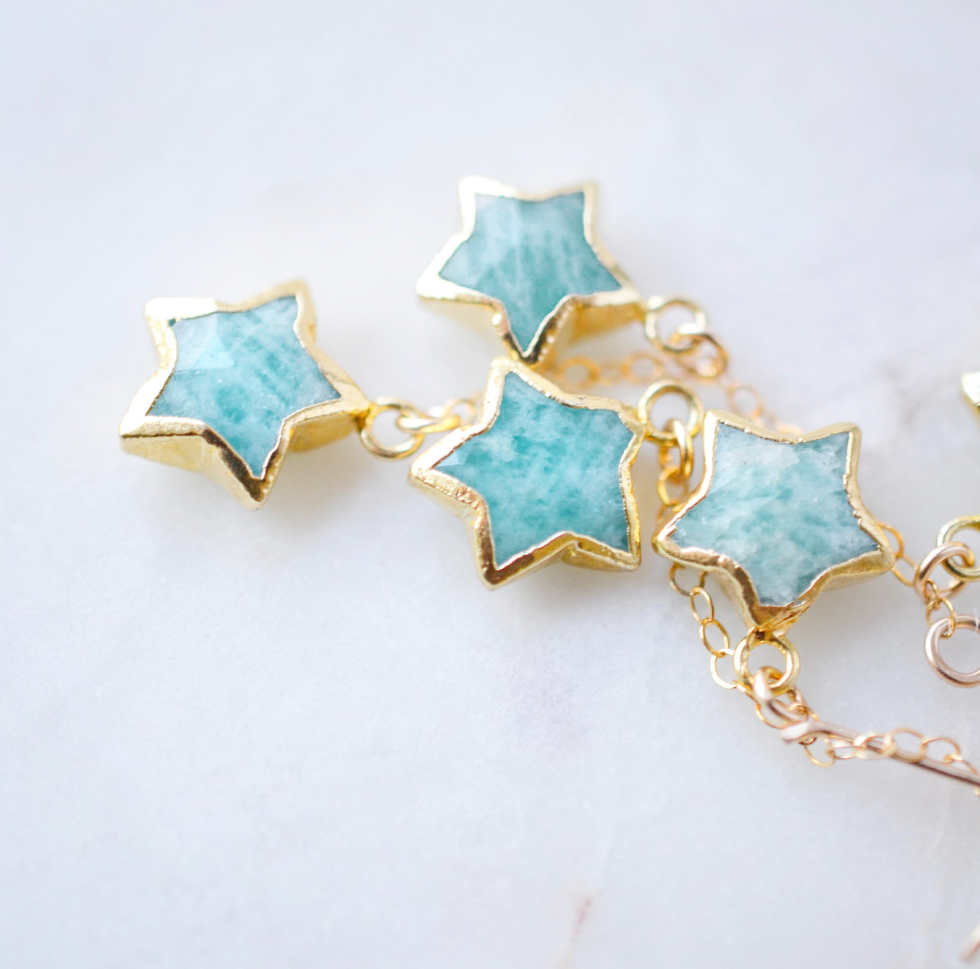 aqua blue star shaped amazonite gemstones set on dangling earrings