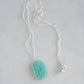 Bright aqua blue Amazonite stone cut into a thin, polished slice with raw edges, then set onto a sterling silver beaded chain.