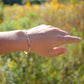 Handmade beaded gemstone crystal bracelet in gold filled or sterling silver. This bracelet is modeled with Tanzanite. These bracelets feature a gemstone of your choice on a bracelet that can be stacked with others or worn alone.