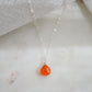 Genuine orange Carnelian crystal teardrop pendant on a sterling silver chain.