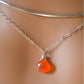 Natural orange Carnelian teardrop gemstone set onto a sterling silver chain.