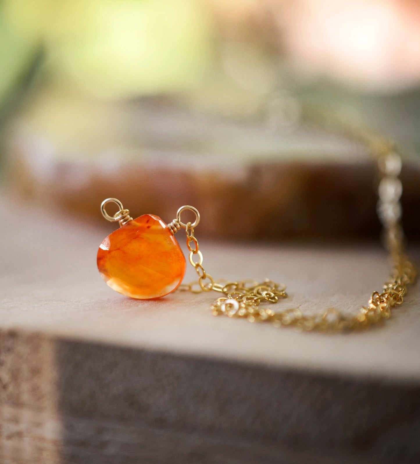 Handmade orange Carnelian Necklace. A single teardrop gemstone placed onto a sterling silver or gold filled chain. Detail Image.