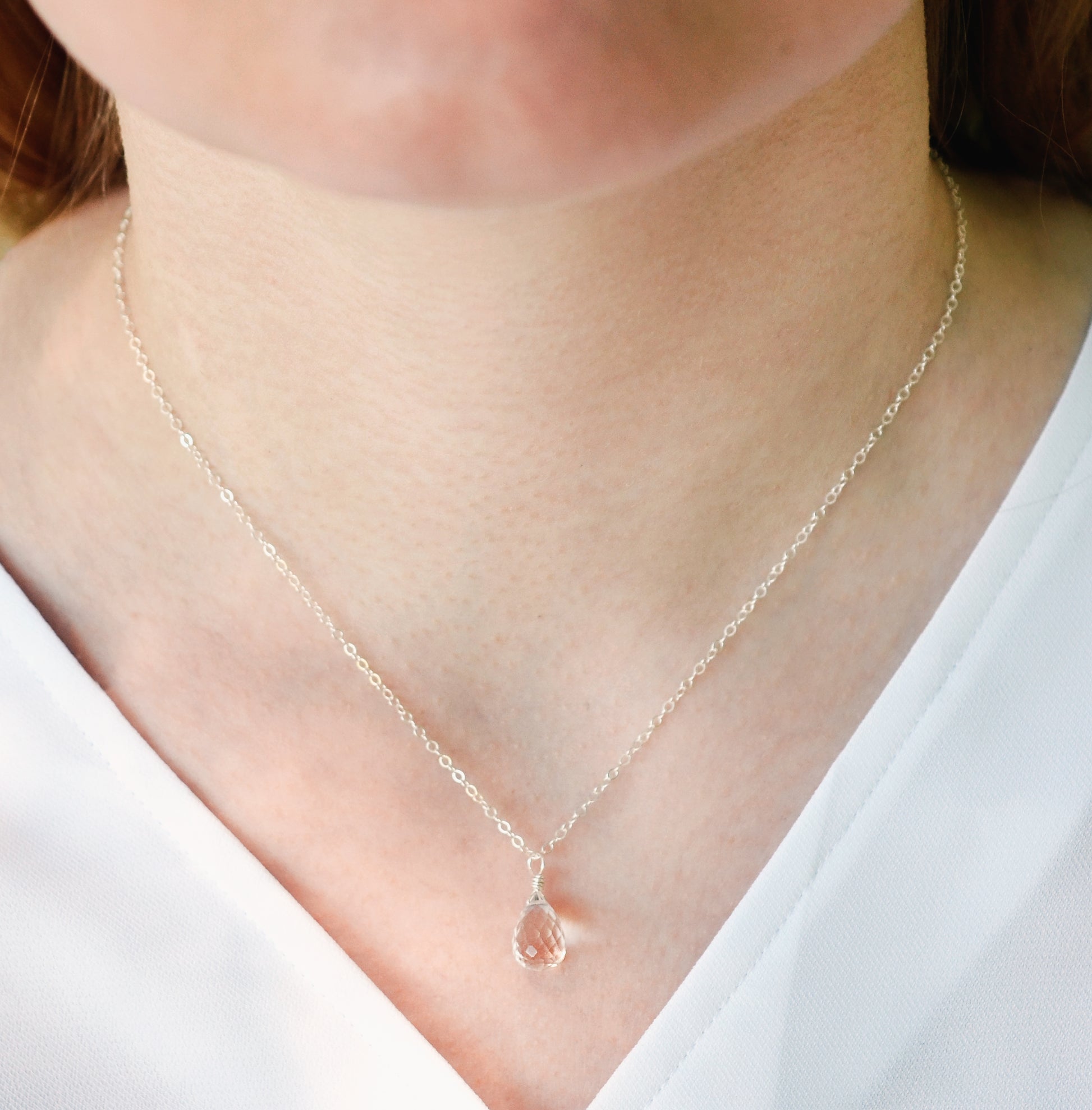 Natural clear rock crystal quartz gemstone on a sterling silver necklace chain.