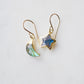 Labradorite Moon and Star earrings. One dangle is a faceted crescent moon, while the other is a star. The stones are naturally gray in color, but shift blue or green with movement. Available in gold or silver.
