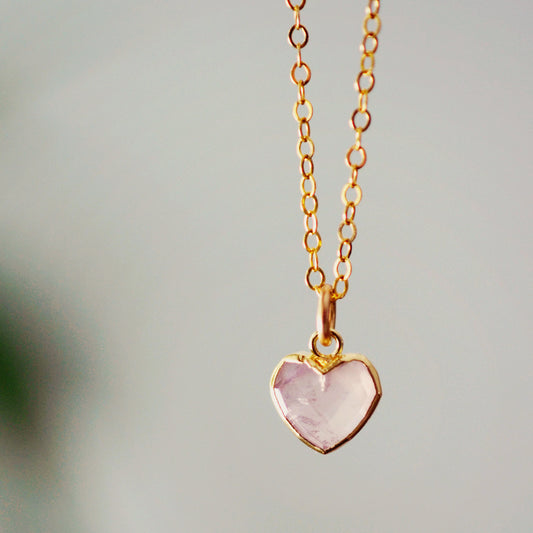 Pink Rose Quartz pendant suspended on a 14k gold filled chain. The Rose Quartz heart is bezeled in gold.