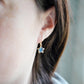 Labradorite Moon and Star earrings. One dangle is a faceted crescent moon, while the other is a star. The stones are naturally gray in color, but shift blue or green with movement. Available in gold or silver.