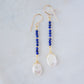Natural blue lapis lazuli gemstone and white freshwater pearl long dangle earrings. The dangles are long and thin with oval freshwater pearls at the end. They come in 14k gold filled and sterling silver.