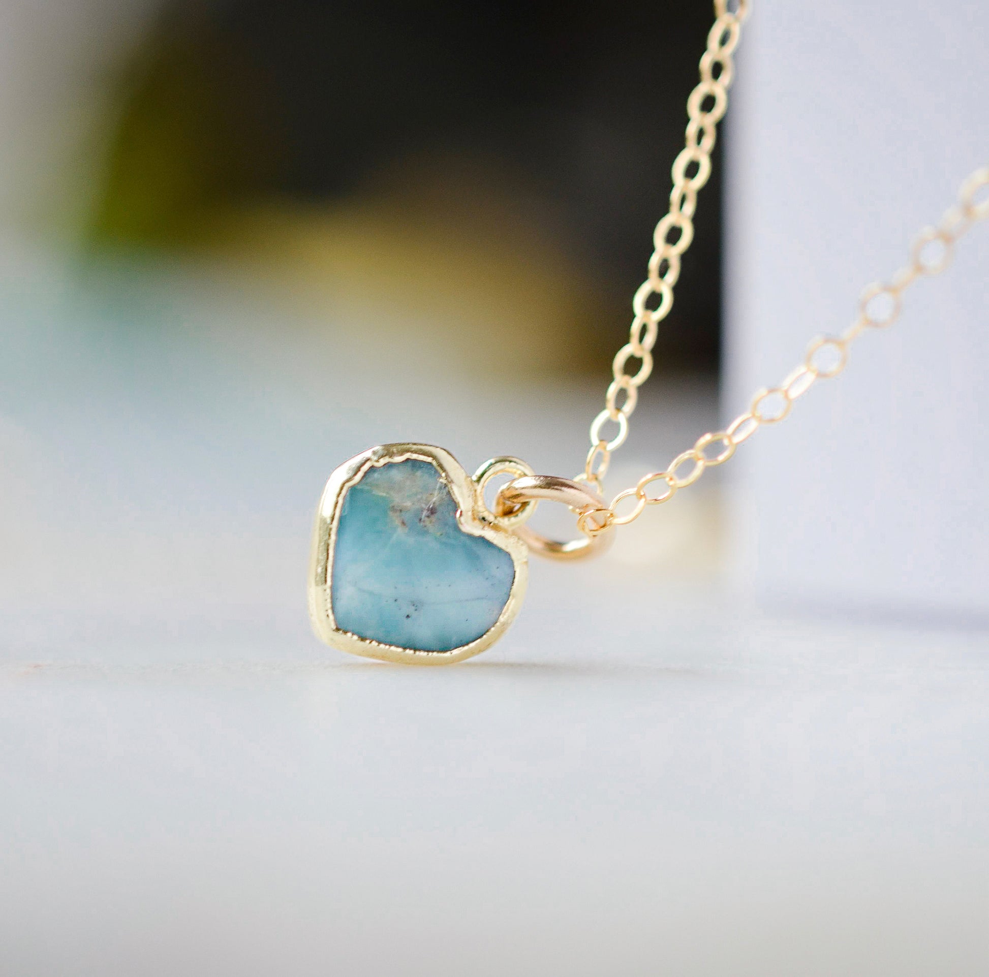 Genuine, real, blue Larimar stone heart necklace. The stone is bezeled in gold and set on a 14k gold filled cable chain. This pendant is a great romantic gift for wife, girlfriend, or valentine's day.