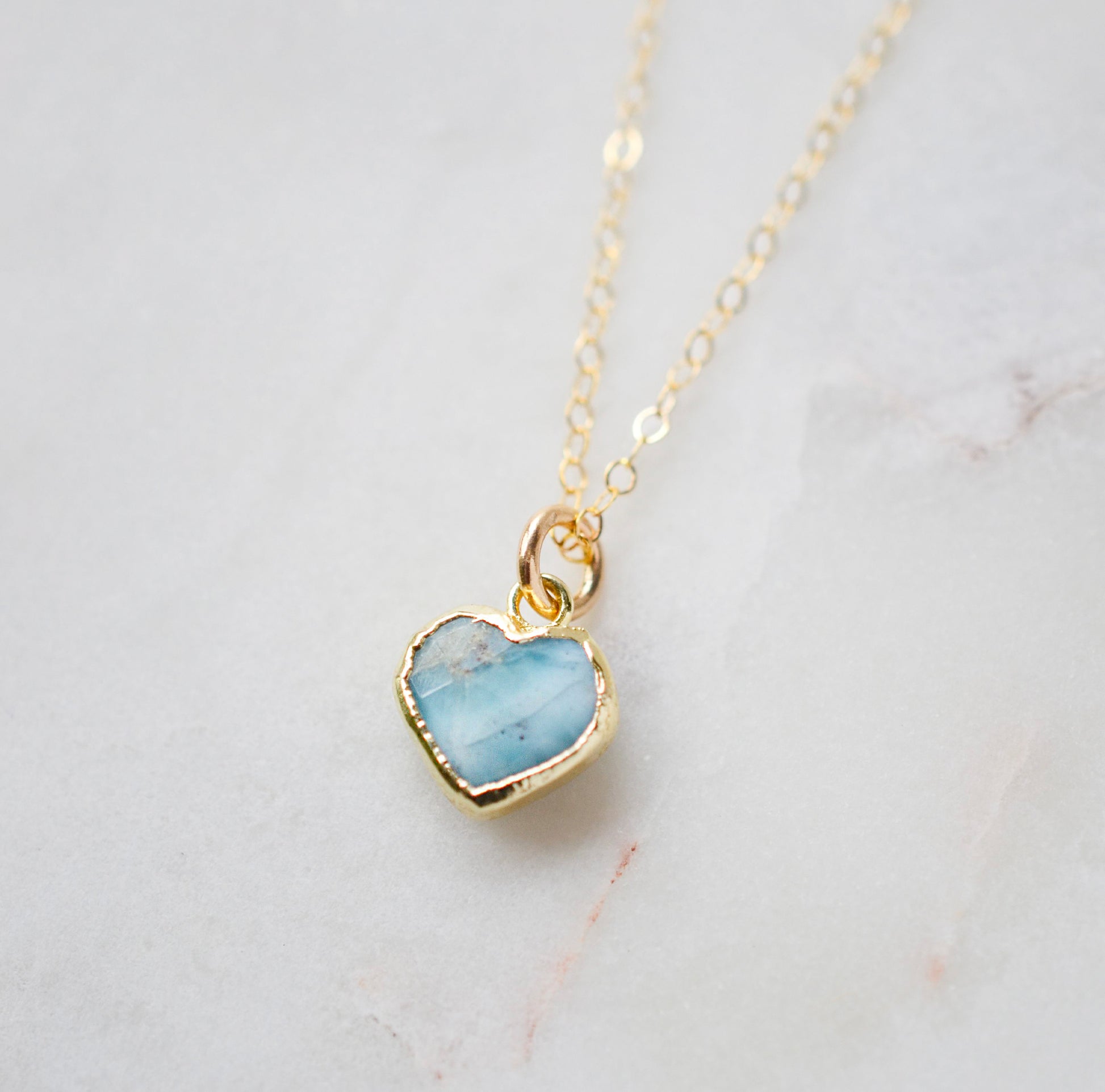 Genuine, real, blue Larimar stone heart necklace. The stone is bezeled in gold and set on a 14k gold filled cable chain. This pendant is a great romantic gift for wife, girlfriend, or valentine's day.