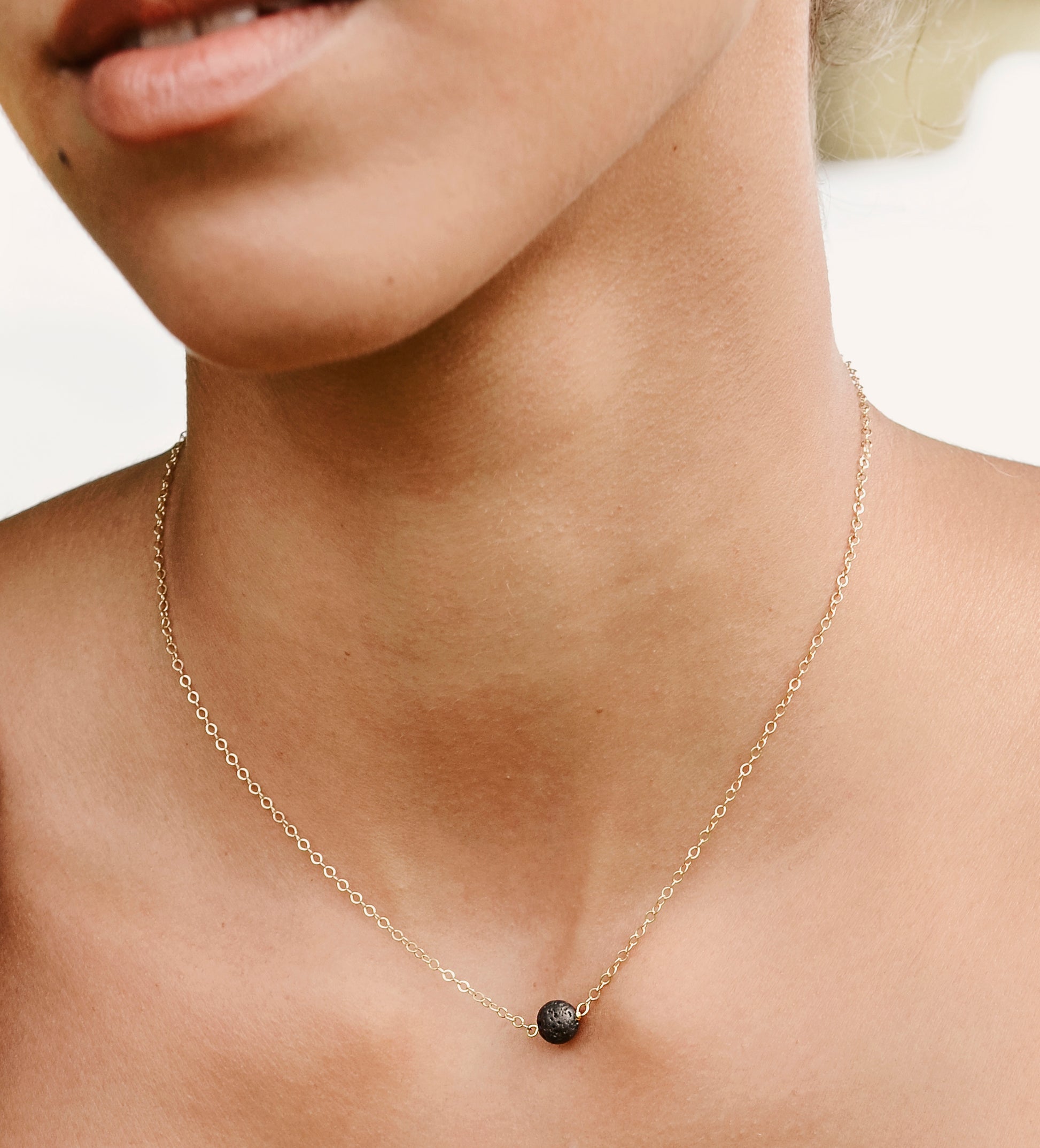Handmade genuine black lava round stone placed onto a gold filled chain. 