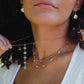 Genuine white freshwater pearls set onto a 14k gold filled chain. Modeled image, layered with other necklaces.