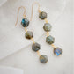 Long fancy labradorite earrings featuring four gemstone dangles in a long like. Each stone contains natural blue and green flash and is a hexagon shape. Dainty, minimalist jewelry handmade in New England by Gemnia.