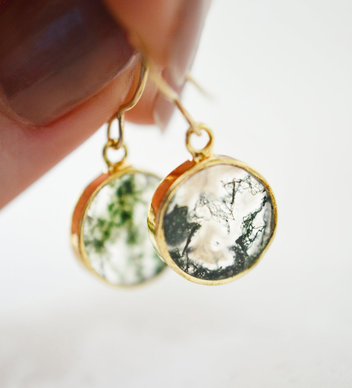 Smooth polished flat circle moss agate earrings shown in gold filled.