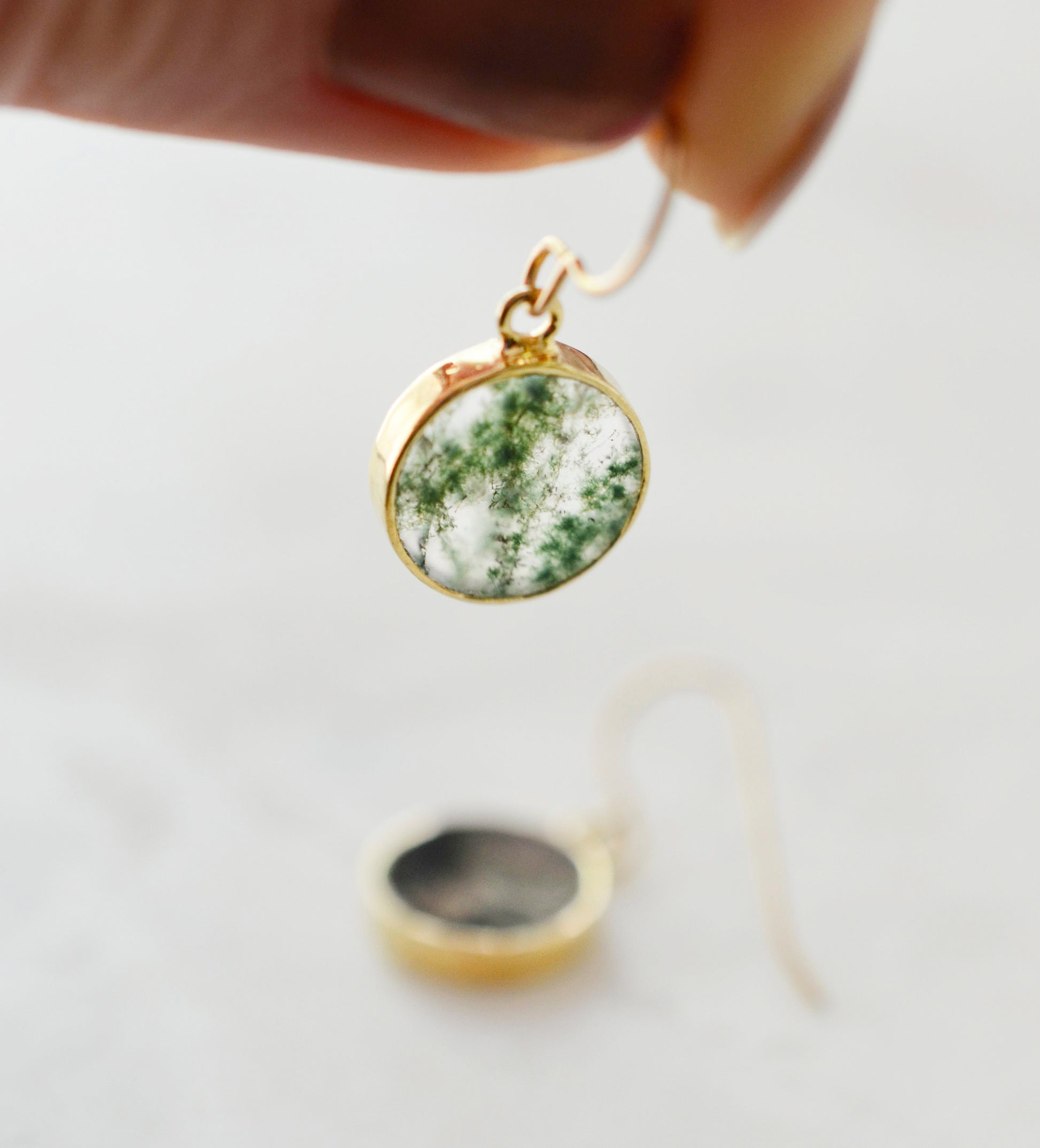 Smooth polished flat circle moss agate earrings shown in gold filled.