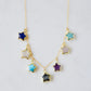 Necklace with star-shaped charms on a 14k gold filled chain. Each star is a different gemstone. Stones include: Lapis lazuli, rainbow moonstone, turquoise, labradorite, amethyst, rose quartz, and amazonite. This necklace is handmade in Connecticut by Gemnia.