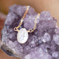 Single white oval shaped freshwater pearl suspended from a 14k gold filled cable chain. 