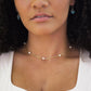 White freshwater pearls set onto a gold paperclip style chain. Modeled image.