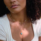 White freshwater pearls set onto a gold paperclip style chain. Modeled image with a Turquoise pendant.