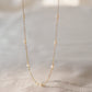 Genuine white freshwater pearls set onto a 14k gold filled chain. 