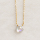 A heart shaped briolette teardrop faceted mystic topaz crystal set on a 14k gold filled chain. The dainty gemstone is clear and shifts rainbow colors with movement. This necklace is handmade in Connecticut by Gemnia and also available in sterling silver. 