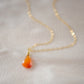 Natural orange triangular shaped Carnelian gemstone set onto a gold chain. Stones vary in color from orange to red.