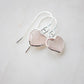 Dainty, handcrafted rose quartz heart earrings featuring a faceted, sparkling heart—the stone of universal love. These gentle dangles, approximately 0.5 inches (12mm/1.2cm) in size, are shown in sterling silver and are also available in 14k gold filled. They make a sweet and thoughtful gift for someone special. 