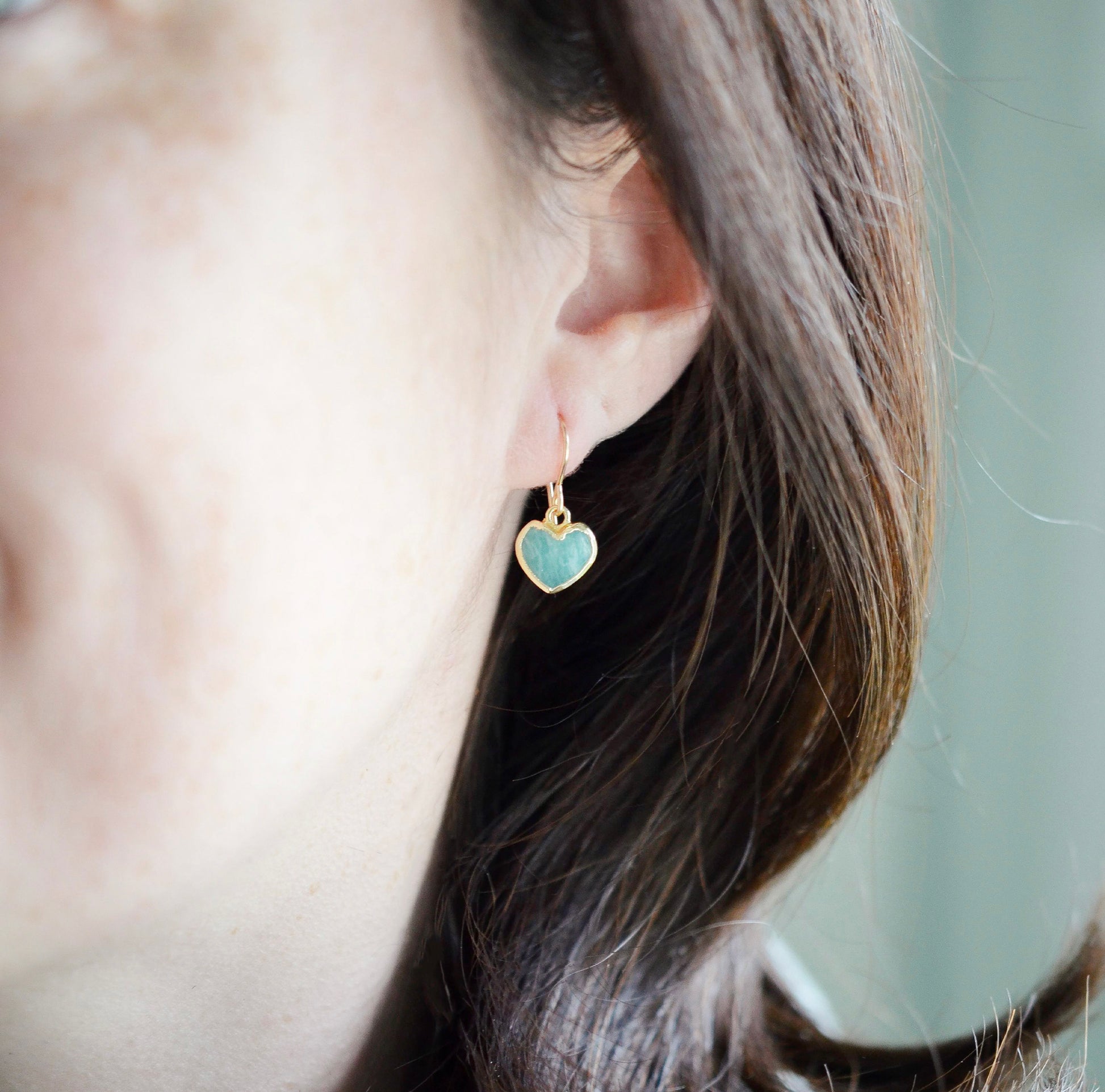 Aqua blue Amazonite gemstone heart earrings in gold. Modeled image. Natural Stones.