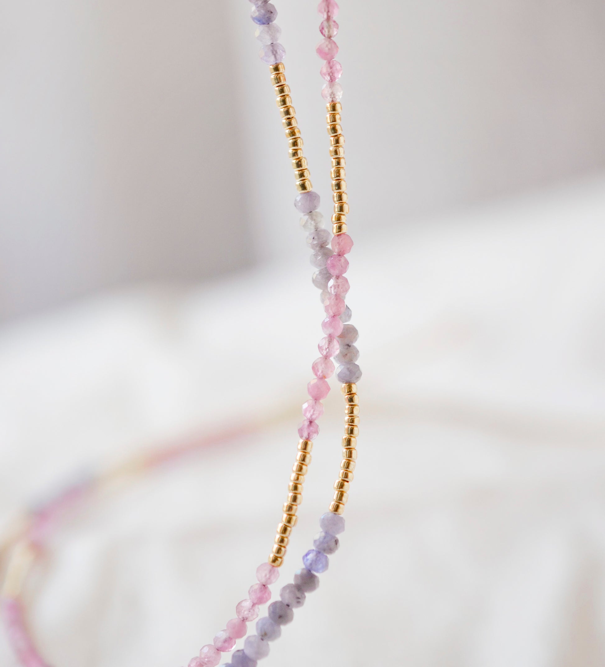 Close up of the Tanzanite and Pink Tourmaline options in gold.