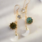 Pair of handmade earrings with star, moon, and turquoise stone designs in 14k gold filled. Handmade in Connecticut by Gemnia.