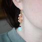 Three sunstone gemstone dangle atop amethyst and amazonite stones. The long earrings are shown in 14k gold filled. Modeled image.